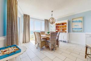a dining room with a table and chairs at Conveniently located Gulf condo with spacious layout pool & pickleball in Seacrest