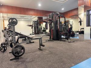 a gym with several treadmills and weights at Pam Premium Hotel Vadodara in Vadodara