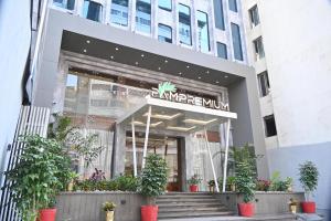 a store front of a building with potted plants at Pam Premium Hotel Vadodara in Vadodara