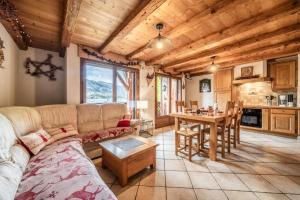 a living room with a couch and a table at La Ferme de Sous-Lachat in Samoëns