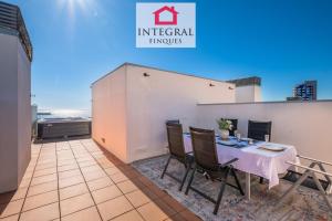 a room with a table and chairs on a balcony at Paradís Platja Apartment in Palamós
