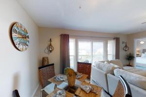 a living room with a couch and a table at 3rd Floor Spacious Condo Close To Entertainment Shared pool Wifi in Navarre +20 photos