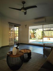a living room with a ceiling fan and a table at Ocean Sands Accommodation in Richards Bay