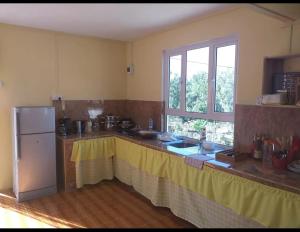 a kitchen with a counter top and a refrigerator at Chez Sanny in Mt Bois Noir