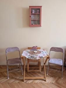 a table and two chairs in a room at KRAGUJ apartments 1 in Kragujevac