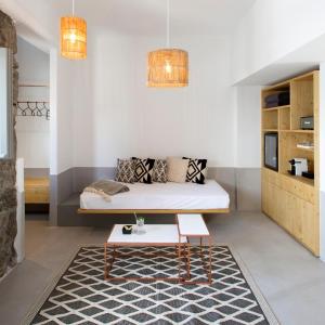 a room with a bed and a coffee table at The Dimora by Mazera in Ornos
