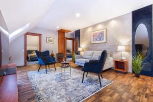 a living room with a couch and chairs at Hotel Gottwald in Tata