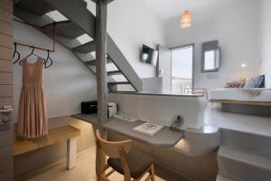 a living room with a staircase and a bedroom at The Dimora by Mazera in Ornos