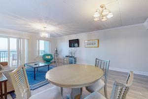 a dining room with a table and chairs in a room at Spacious 3rd-floor beachfront condo with stunning views pool pickleball & AC in Fort Walton Beach +36 photos