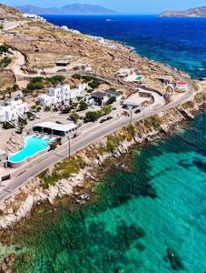 an aerial view of a road next to the ocean at The Dimora by Mazera in Ornos