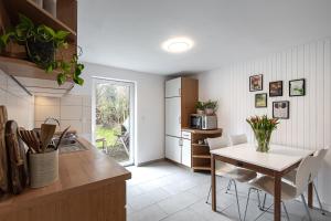 a kitchen and dining room with a table and chairs at Hamburg - Haus - Airport 2 in Hamburg