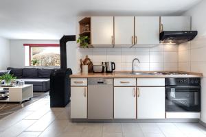 a kitchen with a sink and a stove top oven at Hamburg - Haus - Airport 2 in Hamburg +10 photos