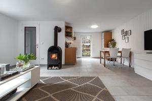 a kitchen and dining room with a fireplace in a living room at Hamburg - Haus - Airport 2 in Hamburg