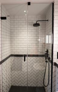a shower with a glass door in a bathroom at Victory House Leicester Square in London