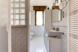 a bathroom with a sink and a toilet at Residenza Quadrifoglio in Cesena +16 photos