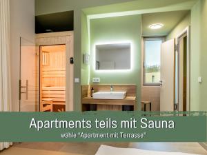 a bathroom with a sink and a mirror at 360 Grad by teamgeist Apartmenthaus - familienfreundlich - direkt am See mitten im Naturpark - Wassersportaktivitäten vor Ort in Kolberg