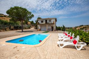 a group of chairs sitting next to a swimming pool at MAS MIRONO in Fraga +8 photos