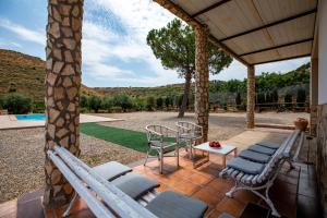 a patio with chairs and a table and a pool at MAS MIRONO in Fraga