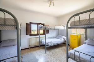 a room with three bunk beds and a yellow drawer at MAS MIRONO in Fraga