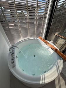 a bath tub in a room with a window at Baan mae resort in Ban Takat Ngao +21 photos