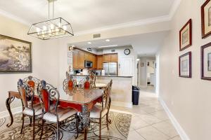 a dining room and kitchen with a table and chairs at First Floor Condo with a Partial Gulf View Splash Pad and More in Fort Walton Beach