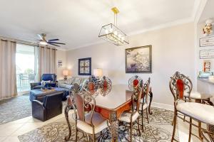 a living room with a table and chairs and a couch at First Floor Condo with a Partial Gulf View Splash Pad and More in Fort Walton Beach