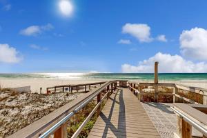 a wooden pathway to the beach with the ocean at First Floor Condo with a Partial Gulf View Splash Pad and More in Fort Walton Beach