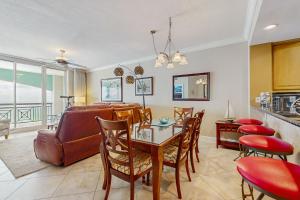 a living room with a table and a couch at Roomy beachfront condo with full kitchen shared pool and beach access in Fort Walton Beach