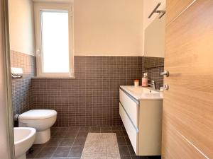 a bathroom with a toilet and a sink at Relax Ligure in Boissano +18 photos
