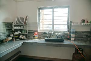 a kitchen with a counter with two bowls on it at White Lotus in North Lakhimpur