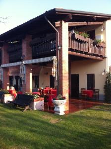 a house with a deck and a table and chairs at Manuela Le Quattro Coppe in Desenzano del Garda