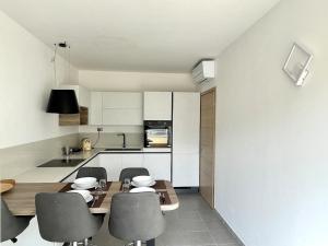 a kitchen with a table and chairs and a counter at Relax Ligure in Boissano
