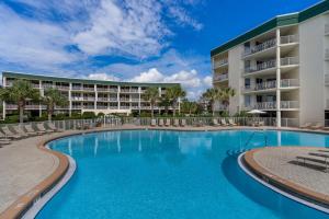 a swimming pool in front of a resort at Chic first-floor condo with Gulf & pool view & pickleball - steps to beach in Santa Rosa Beach