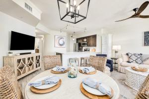 a living room with a table and chairs at Chic first-floor condo with Gulf & pool view & pickleball - steps to beach in Santa Rosa Beach +53 photos