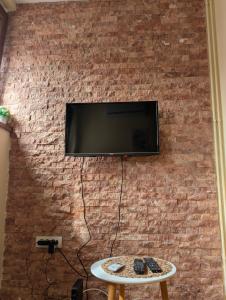 a brick wall with a flat screen tv on a wall at KRAGUJ apartments 1 in Kragujevac