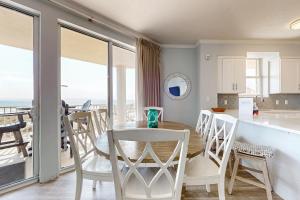 a kitchen and dining room with a table and chairs at Ground floor beachfront condo with shared pool and beach access in Santa Rosa Beach +42 photos