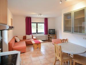 a living room with a couch and a table at Apartment with private terrace in H ddinge in Bad Wildungen