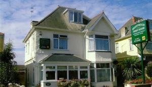 a white house with a sign in front of it at Brantwood Guest House in Christchurch