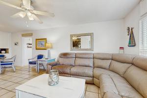 a living room with a couch and a table at Spacious home with balconies shared pool and beach access in Fort Walton Beach +29 photos