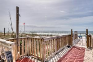 a wooden walkway to a beach with the ocean at Spacious home with balconies shared pool and beach access in Fort Walton Beach