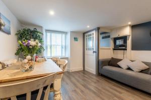 a kitchen and living room with a couch and a table at 3 Bed in Appledore oc-cockle in Appledore