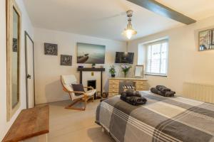 a bedroom with a large bed and a fireplace at 3 Bed in Appledore oc-cockle in Appledore
