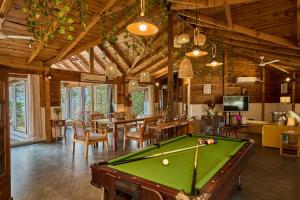 a living room with a pool table in it at SaffronStays Anjee's Chalet in Dhamni
