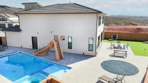 a house with a swimming pool and a slide at Splash and Putt Paradise home in Washington