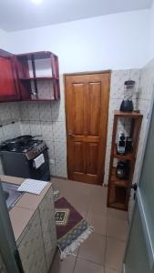 a small kitchen with a door and a counter top at Home Soft in Douala