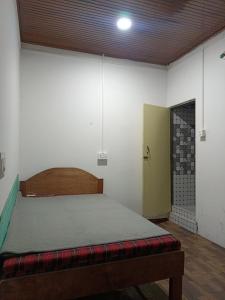 a bedroom with a bed in a room with a door at Pines pool homestay in Darjeeling