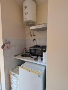 a small kitchen with a sink and a refrigerator at KRAGUJ apartments 1 in Kragujevac