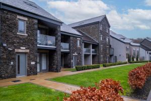 a row of houses with a green lawn at 34 Ironworks in Backbarrow