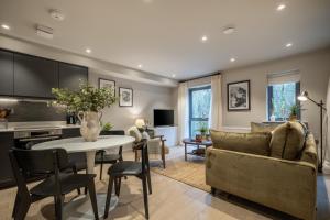 a living room with a table and a couch at 34 Ironworks in Backbarrow