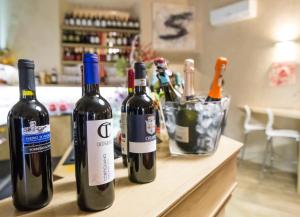 two bottles of wine sitting on top of a counter at La casa di Lollo in Piombino